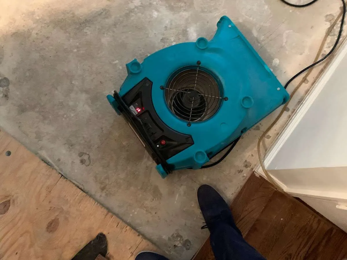 Air mover drying subfloor during Commercial Water Damage Restoration in Wausau